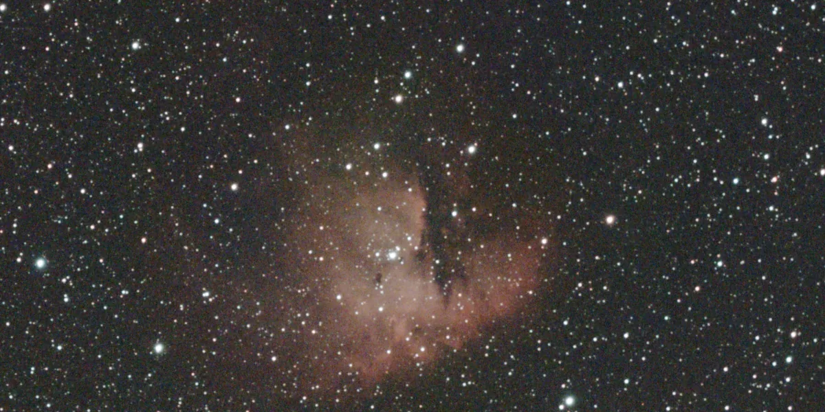 The same field as the DWARF app saves it: a dense star field on a grey-brown sky, with the nebula as a faint, washed-out pink glow.
